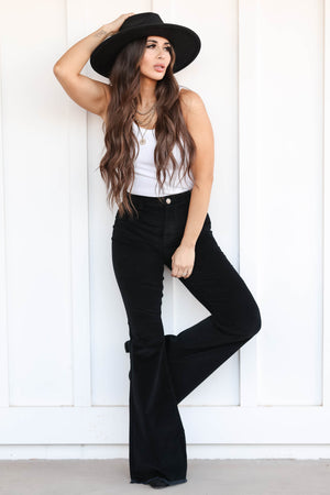 Chloe Corduroy Flare Pants - Black front leaning on wall